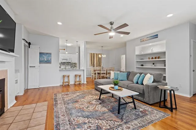 a living room with furniture a rug and a flat screen tv