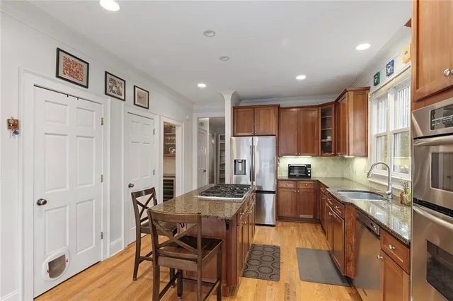 a kitchen with stainless steel appliances granite countertop a stove and a refrigerator
