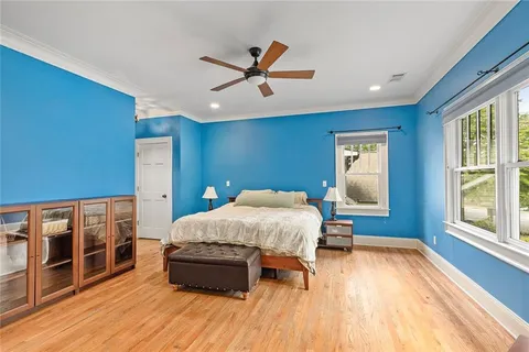 a bed room with a bed and a ceiling fan