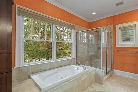 a bedroom with a bed and a dresser with wooden floor