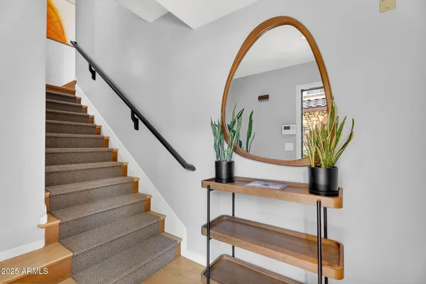 a view of staircase with wooden floor and a potted plant