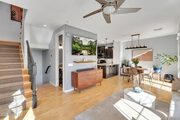 a living room with furniture and kitchen view