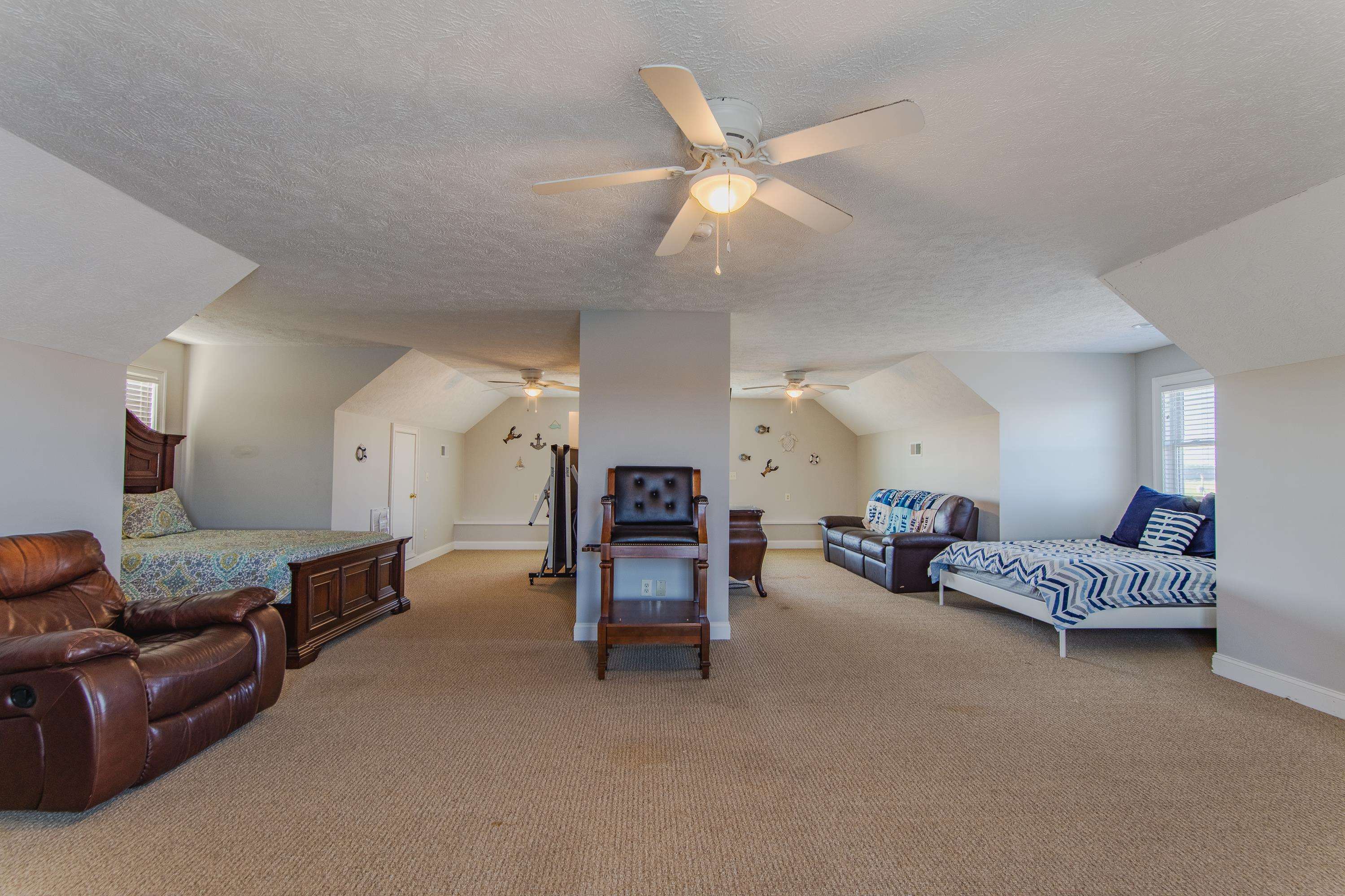 1111 Leaning Trees Lane Adamsville, TN 38310 - Photo 16 of 36 Bedroom featuring a textured ceiling, ceiling fan, light colored carpet, and vaulted ceiling