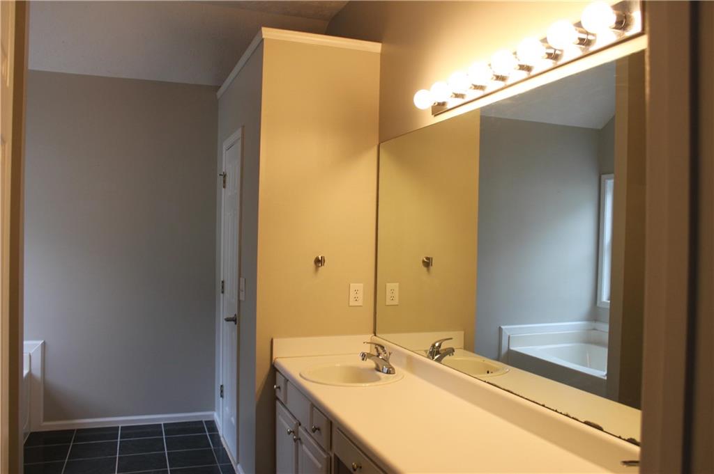 1250 Springmont Court Lawrenceville, GA 30043 - Photo 11 of 16 a bathroom with a sink and a mirror