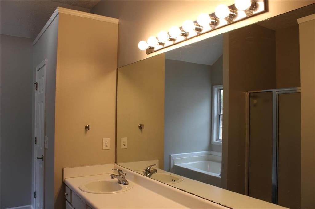 1250 Springmont Court Lawrenceville, GA 30043 - Photo 12 of 16 a bathroom with a sink and a mirror
