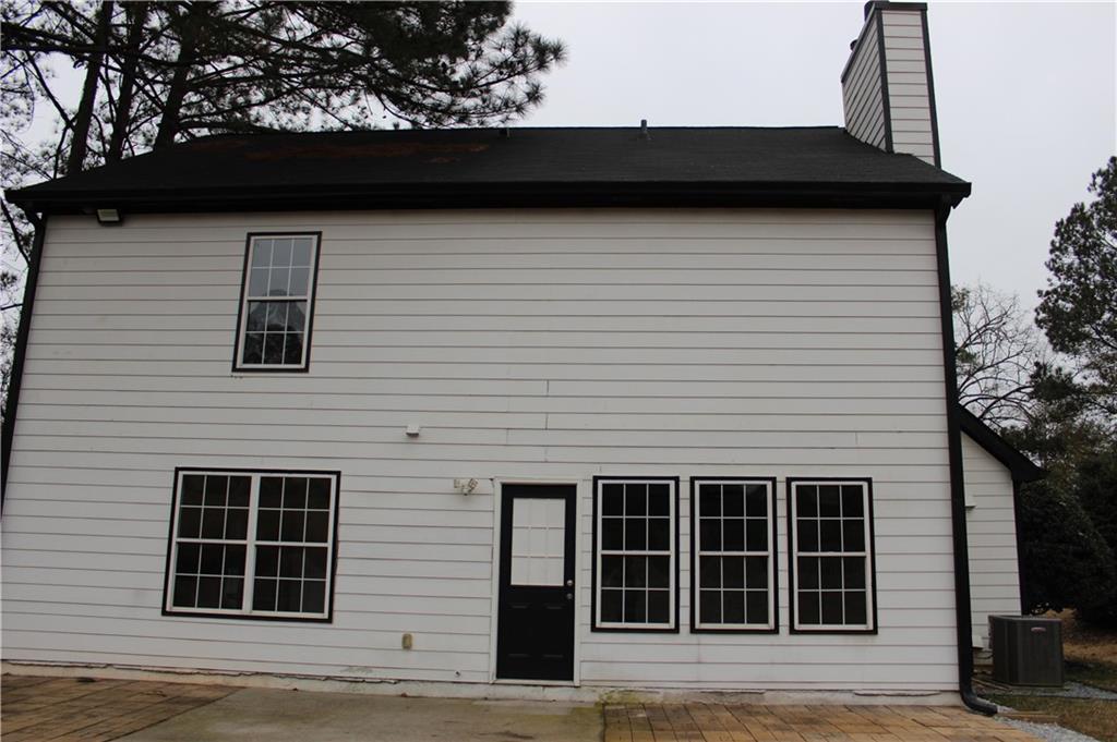 1250 Springmont Court Lawrenceville, GA 30043 - Photo 15 of 16 a view of a house with a large window and brick wall