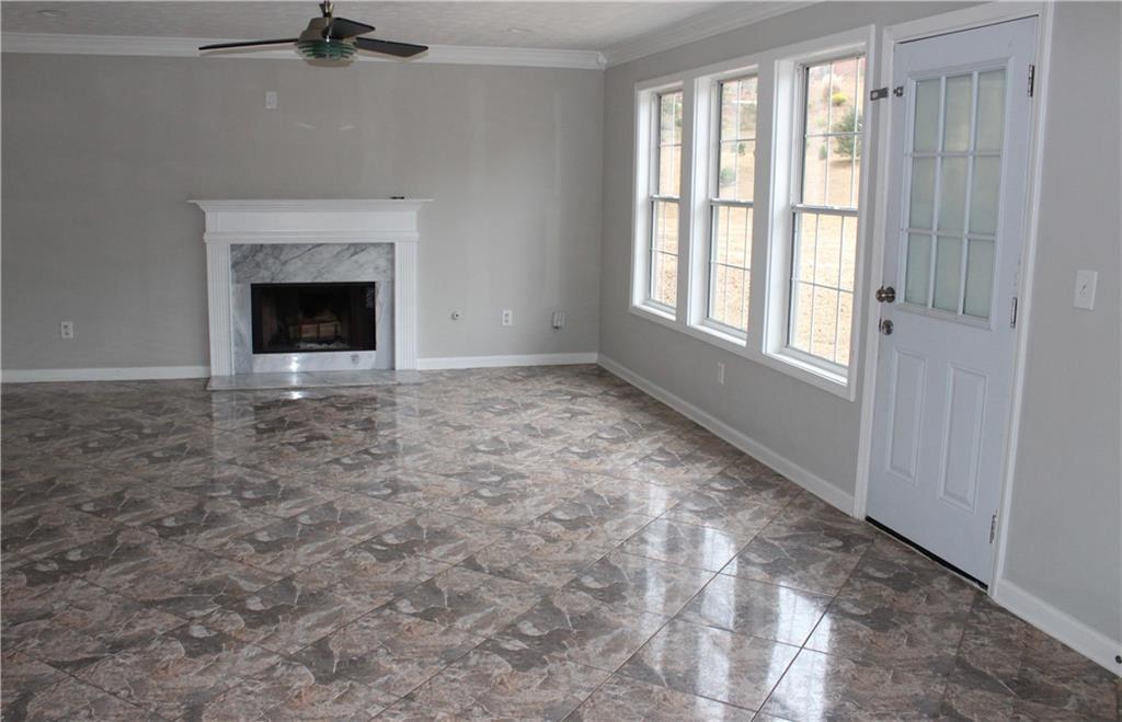 1250 Springmont Court Lawrenceville, GA 30043 - Photo 2 of 16 a view of an empty room with a fireplace and a window