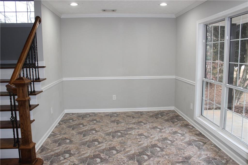 1250 Springmont Court Lawrenceville, GA 30043 - Photo 4 of 16 a view of an empty room with wooden floor and entryway