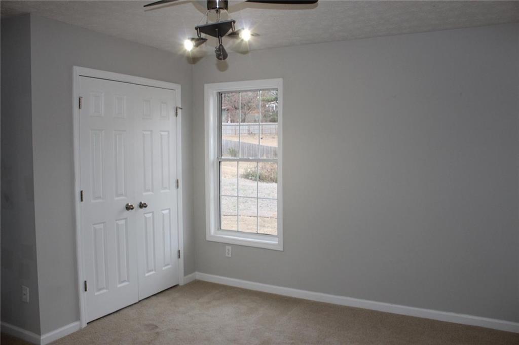 1250 Springmont Court Lawrenceville, GA 30043 - Photo 6 of 16 an empty room with windows and fan