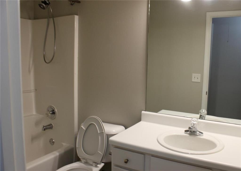 1250 Springmont Court Lawrenceville, GA 30043 - Photo 8 of 16 a bathroom with a sink toilet and shower