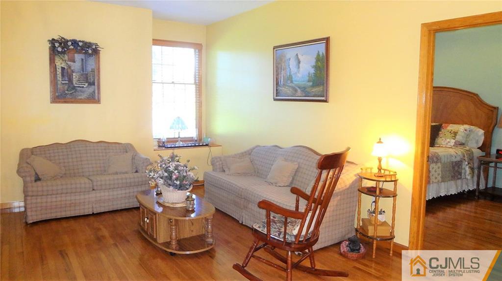 5 Verdi Road Monroe Township, NJ 08831 - Photo 22 of 25 a living room with furniture and a wooden floor