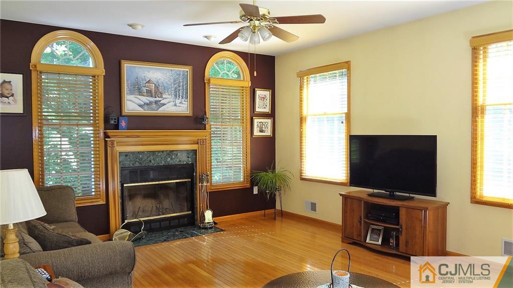 5 Verdi Road Monroe Township, NJ 08831 - Photo 6 of 25 a living room with a fireplace and a flat screen tv