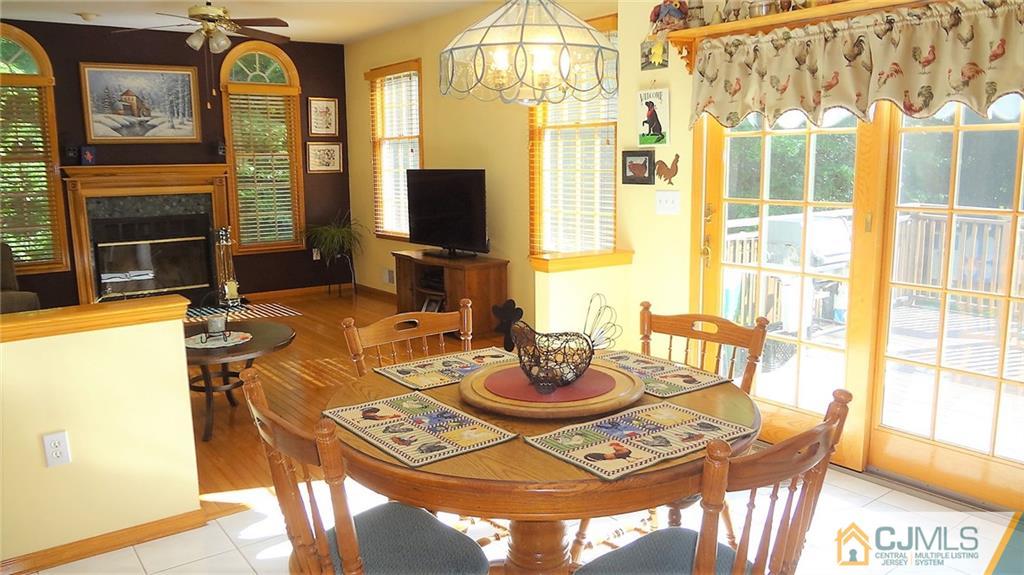 5 Verdi Road Monroe Township, NJ 08831 - Photo 7 of 25 a view of a dining room with furniture a chandelier and wooden floor