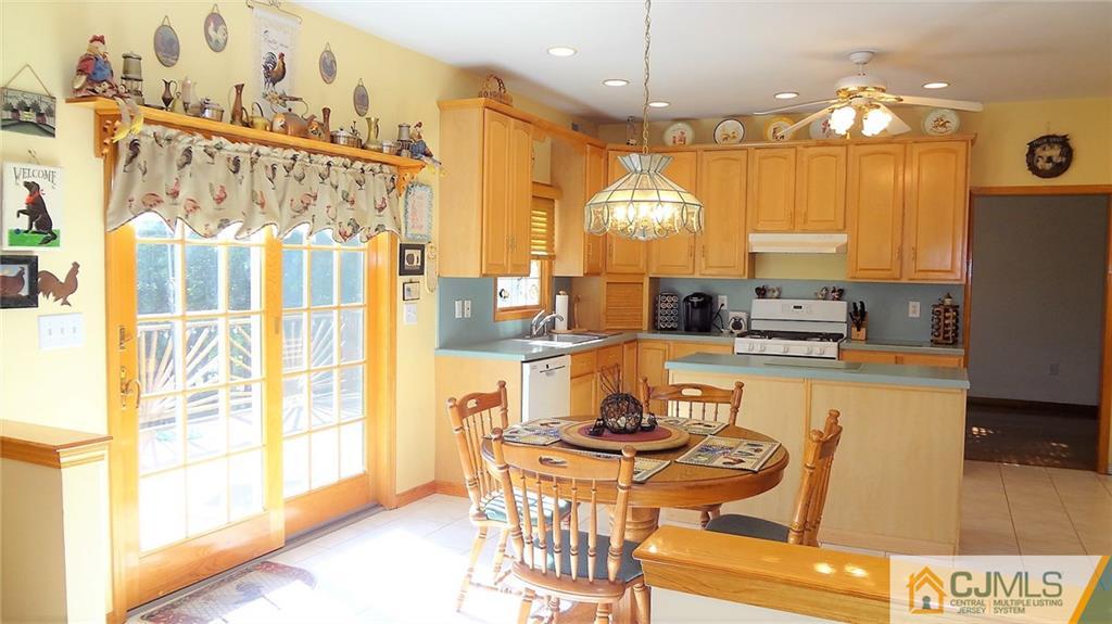 5 Verdi Road Monroe Township, NJ 08831 - Photo 8 of 25 a dining table chairs next to a window with kitchen view
