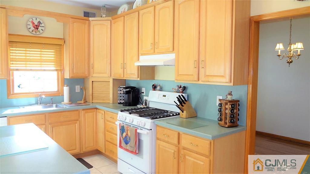 5 Verdi Road Monroe Township, NJ 08831 - Photo 10 of 25 a kitchen with a stove a sink and a cabinets