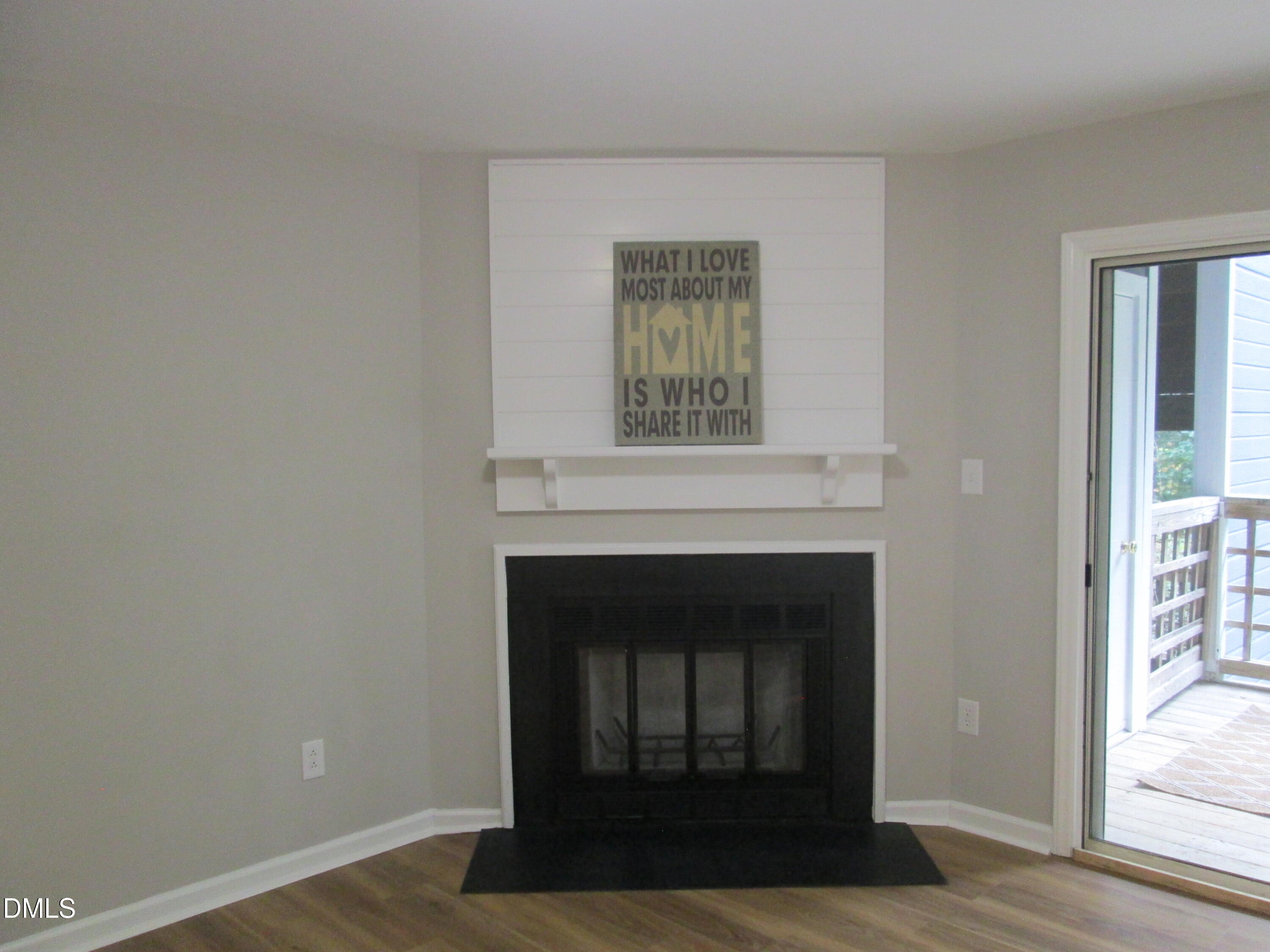 4651 Timbermill Court, Unit 103 Raleigh, NC 27612 - Photo 16 of 31 a living room with a fireplace and a window