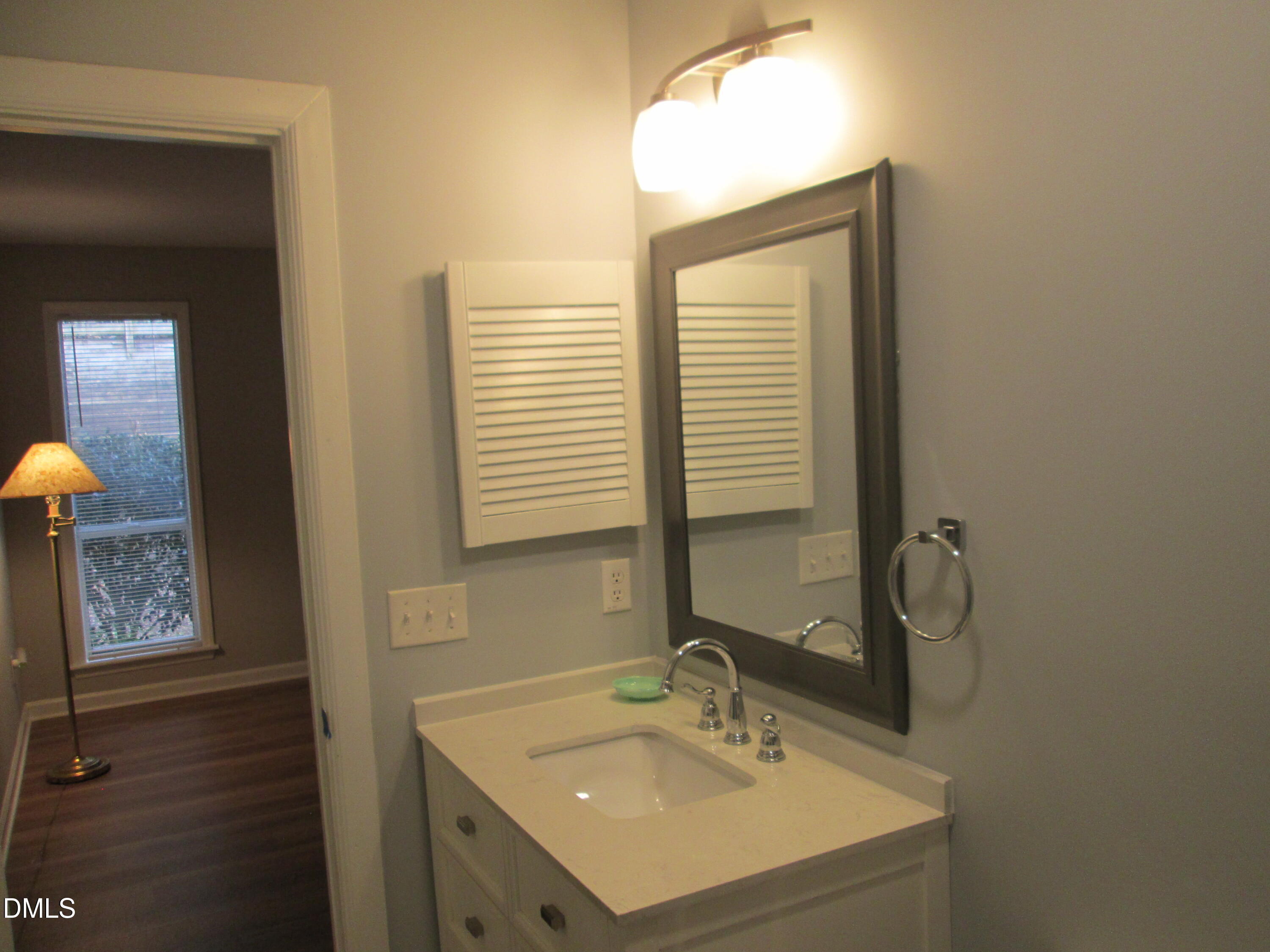4651 Timbermill Court, Unit 103 Raleigh, NC 27612 - Photo 23 of 31 a bathroom with a sink and a mirror