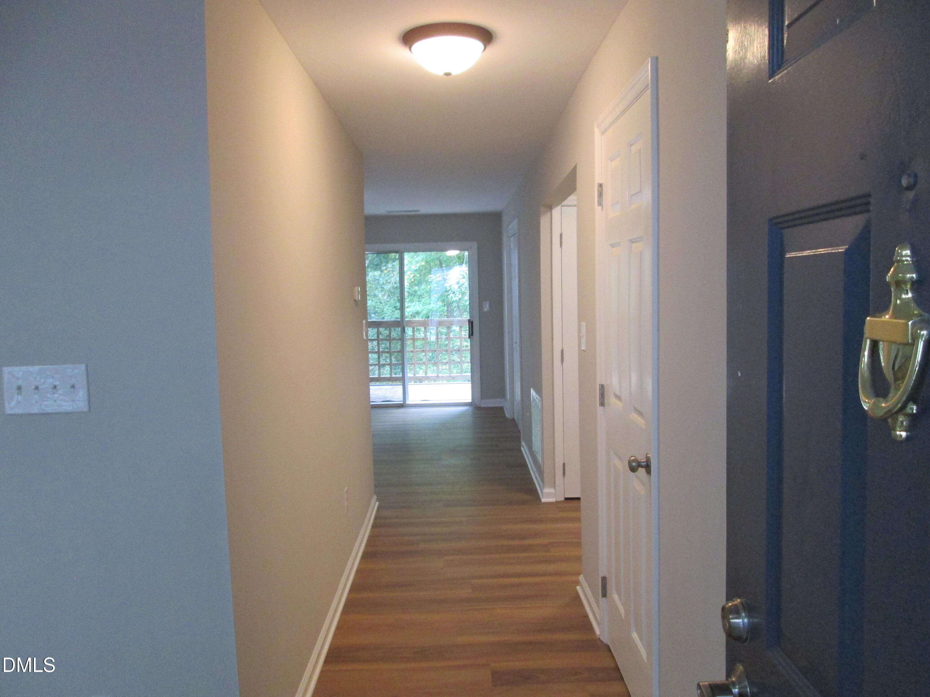 4651 Timbermill Court, Unit 103 Raleigh, NC 27612 - Photo 3 of 31 a view of a hallway with wooden floor and staircase