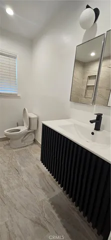 a bedroom with a bed and a mirror