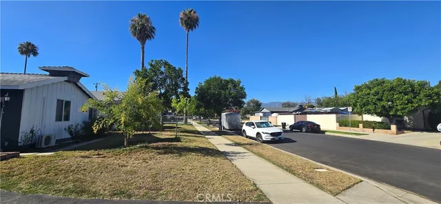 a kitchen with a stove a sink and a refrigerator with wooden floor