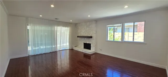 a view of a room with wooden floor and fireplace