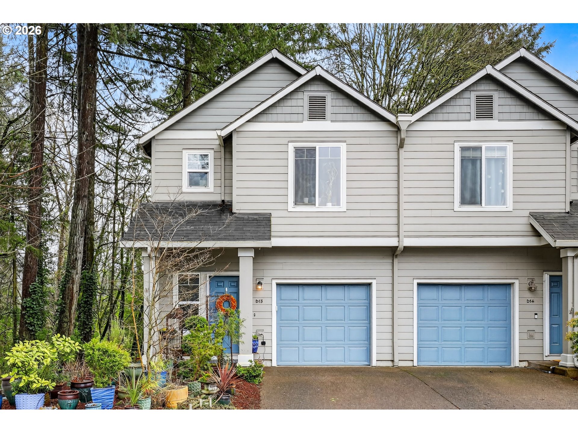 810 East 9th Street, Unit D13 Newberg, OR 97132 - Photo 1 of 42 a front view of a house with a yard and garage