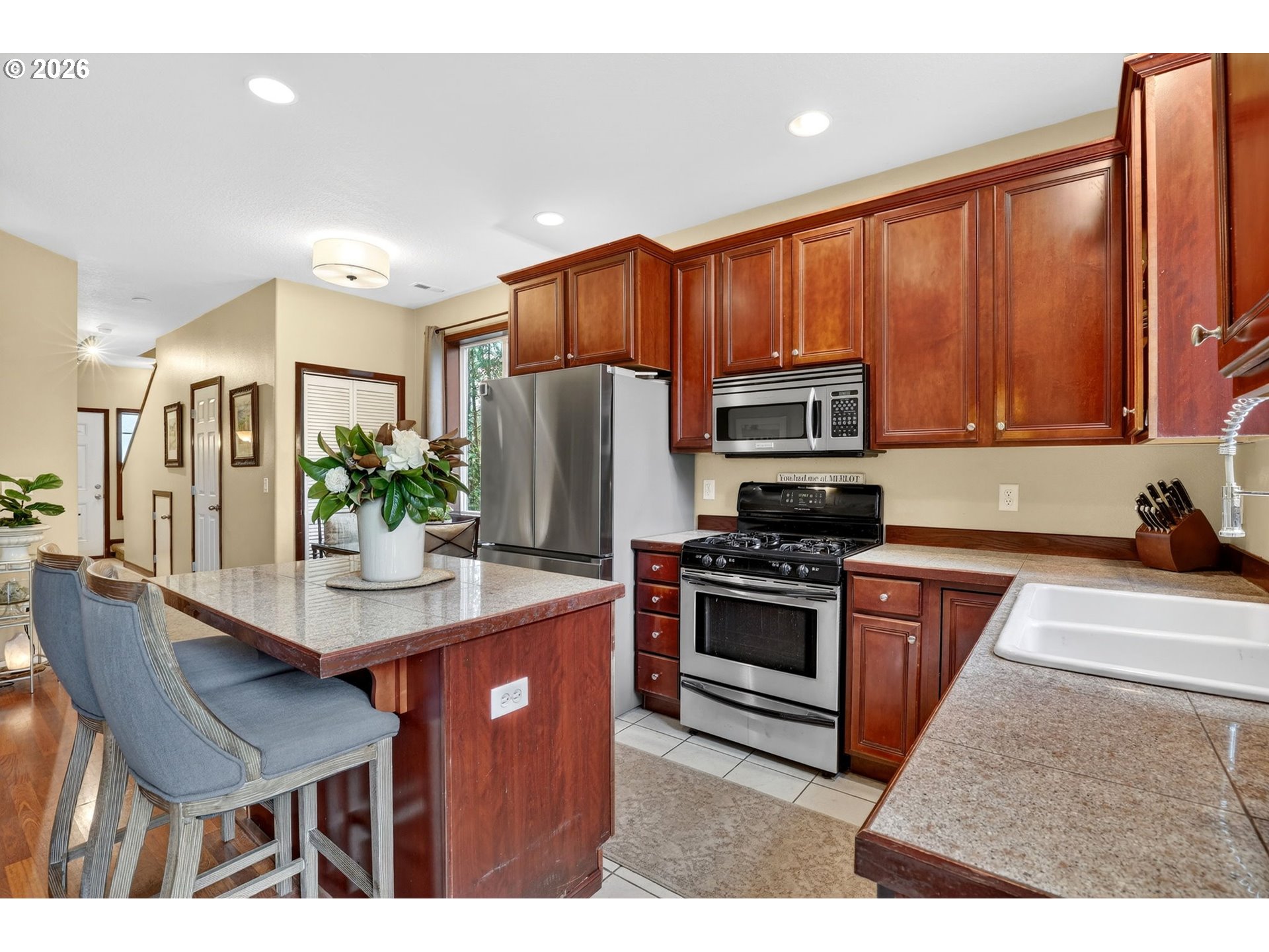 810 East 9th Street, Unit D13 Newberg, OR 97132 - Photo 17 of 42 a kitchen with stainless steel appliances granite countertop a stove refrigerator and a microwave