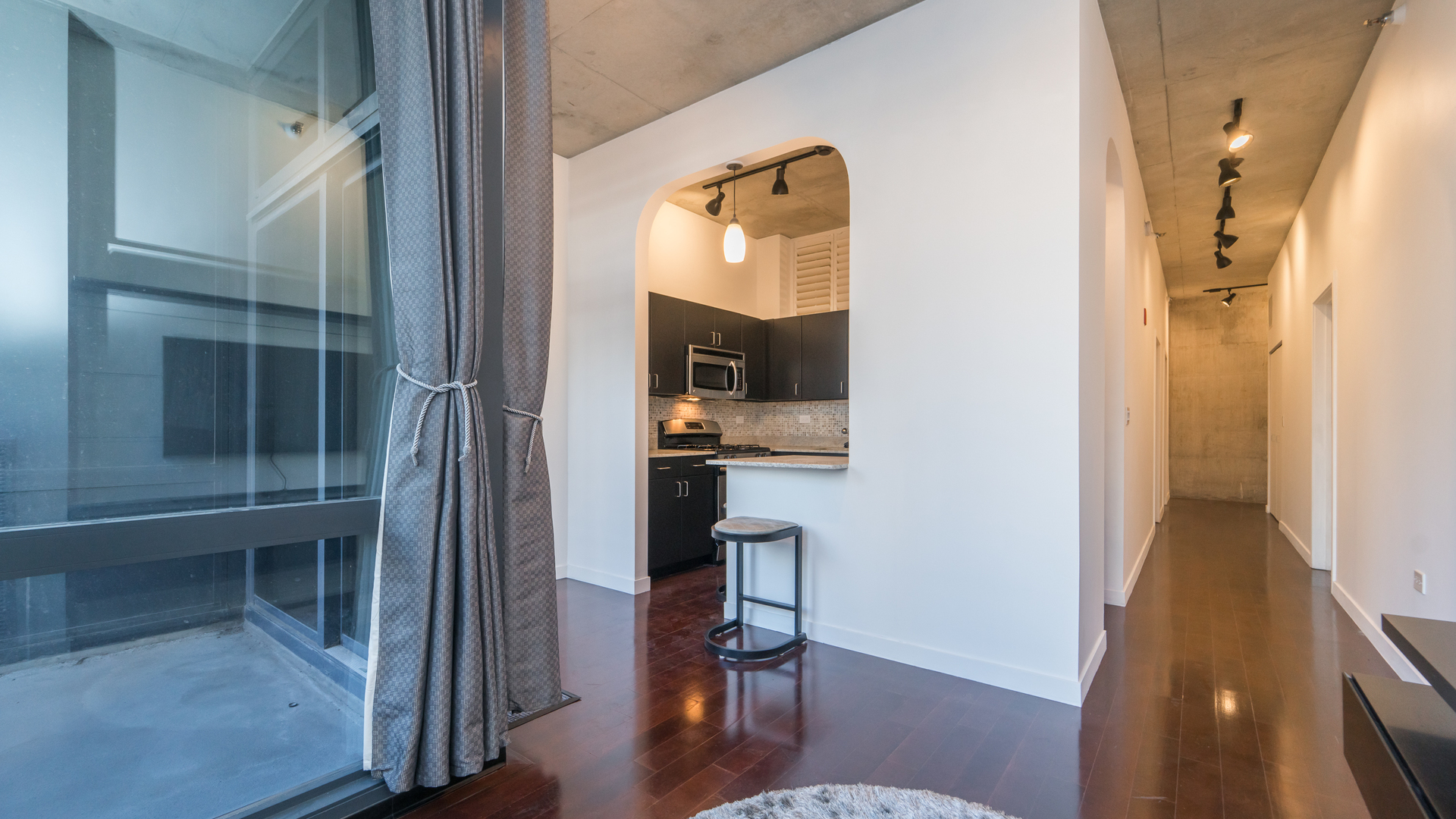 235 West Van Buren Street, Unit 1519 Chicago, IL 60607 - Photo 3 of 10 a view of a hallway with wooden floor and furniture