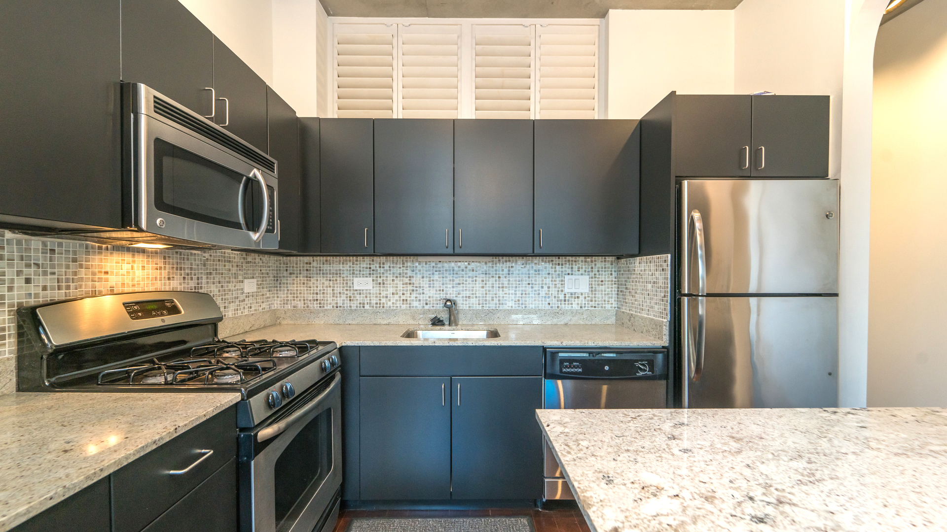 235 West Van Buren Street, Unit 1519 Chicago, IL 60607 - Photo 4 of 10 a kitchen with stainless steel appliances granite countertop a refrigerator stove a sink and dishwasher