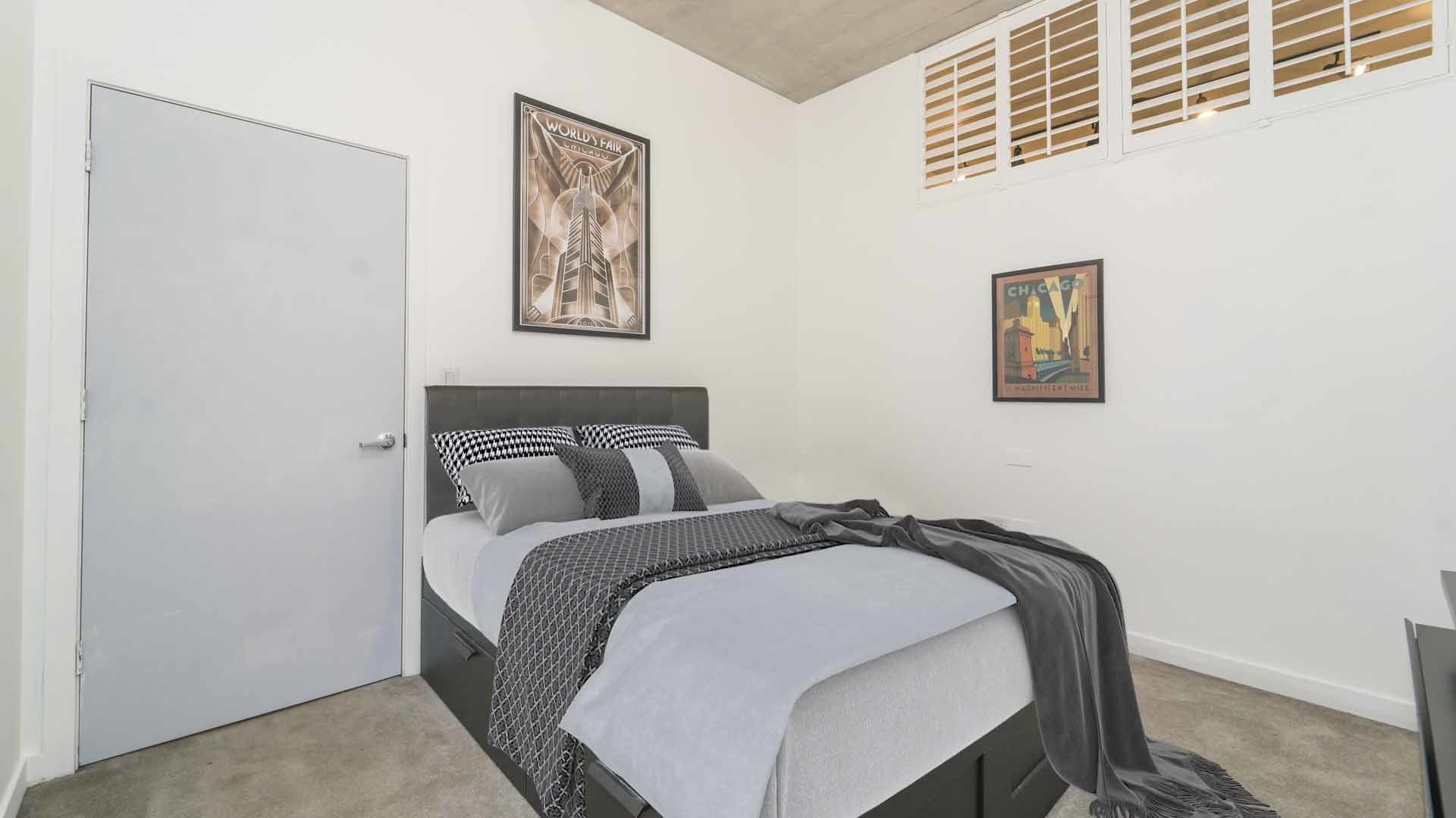235 West Van Buren Street, Unit 1519 Chicago, IL 60607 - Photo 6 of 10 a bed room with a bed and painting on the wall