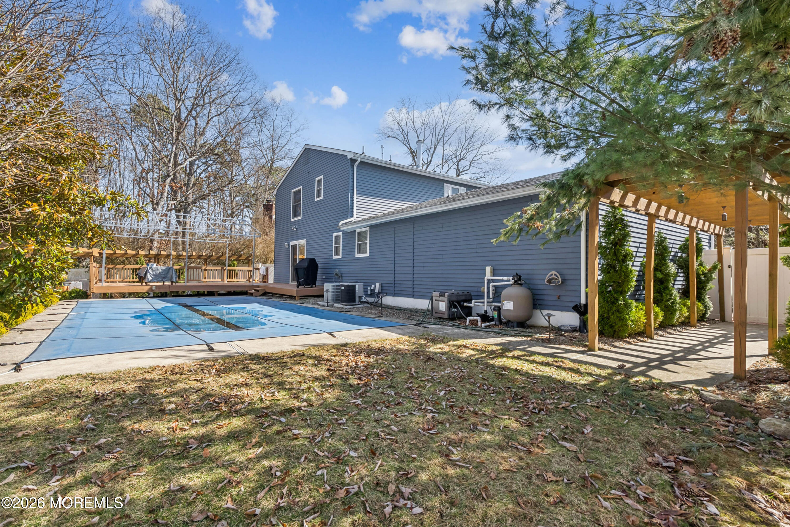 5 Liberty Court Howell, NJ 07731 - Photo 27 of 30 a view of a backyard with table and chairs under an umbrella