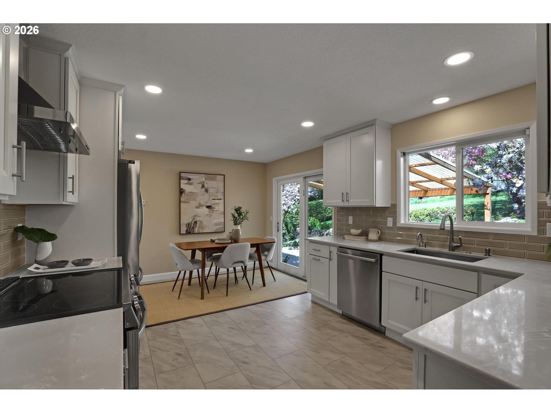 7021 Southwest Canyon Lane Portland, OR 97225 - Photo 8 of 25 a kitchen with lots of counter top space dining table and stainless steel appliances