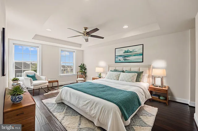 a spacious bedroom with a large bed and a chandelier