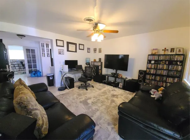 a view of a livingroom with furniture and a flat screen tv