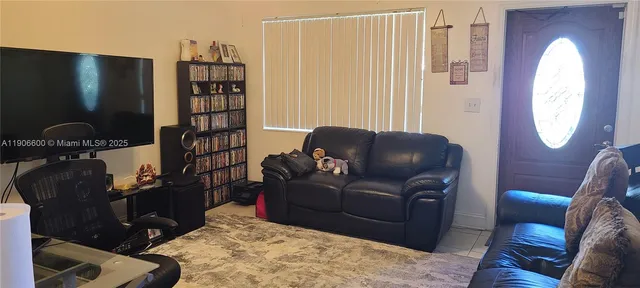 a living room with furniture a rug and a window