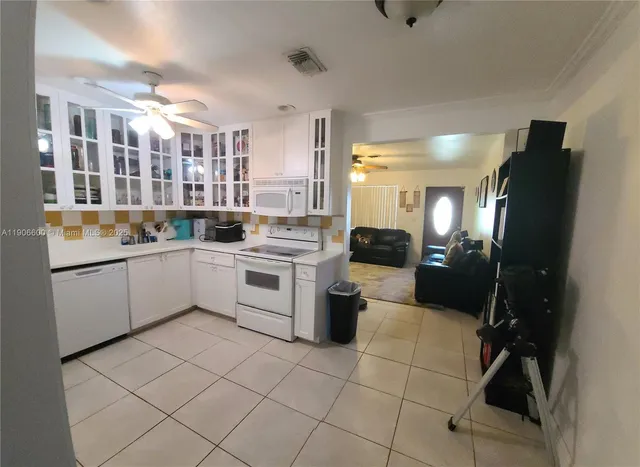 a kitchen with a sink cabinets and stainless steel appliances