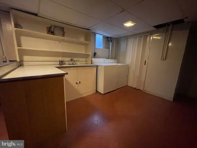 a view of storage and utility room with two washing machine