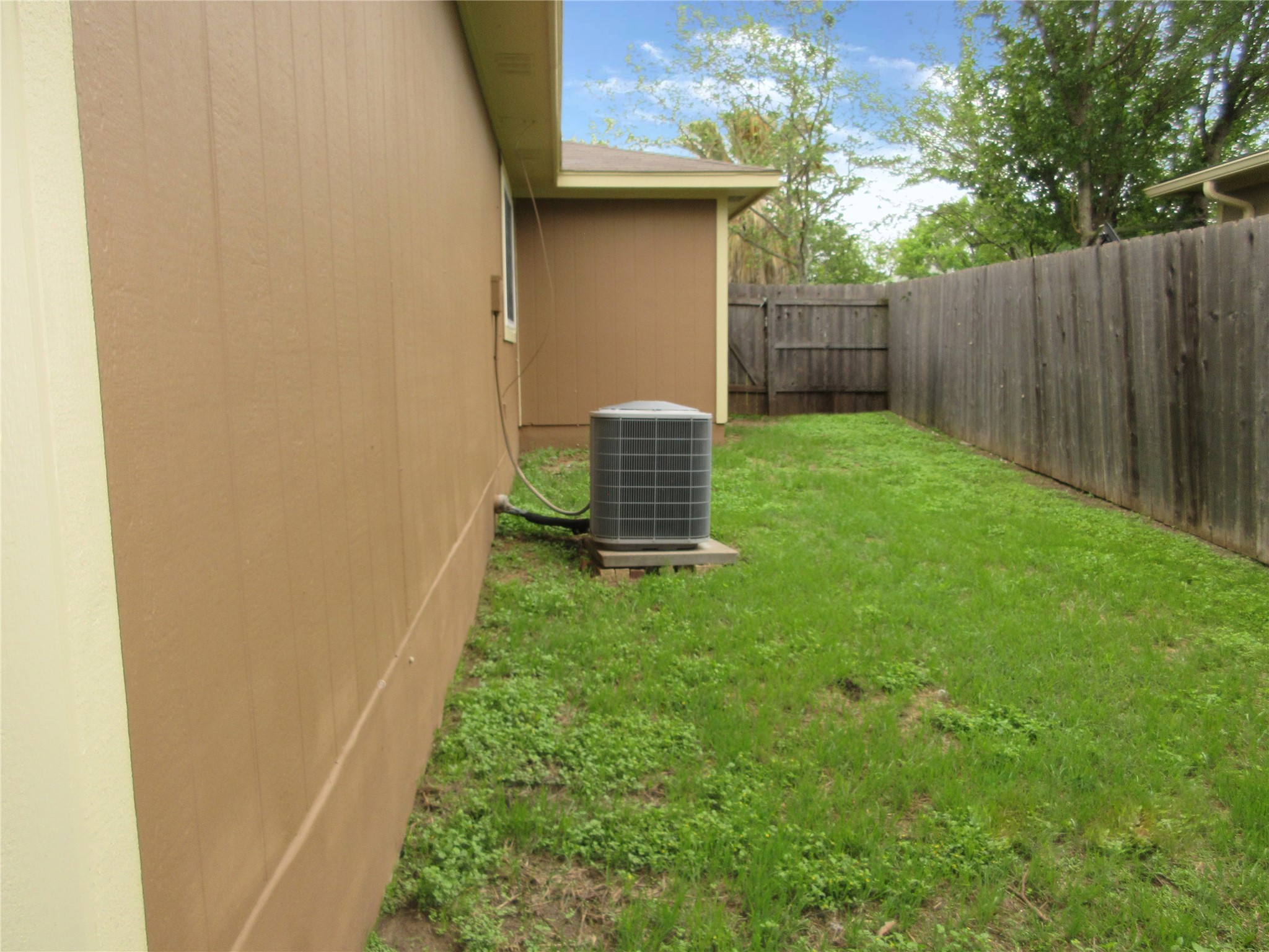 115 Rei Tang Loop Kyle, TX 78640 - Photo 14 of 17 a view of a backyard with wooden fence
