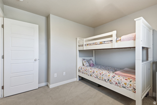3244 West 1670th Street North Provo, UT 84601 - Photo 35 of 56 Carpeted room featuring light gray walls, white baseboards, and a white paneled door with a silver knob