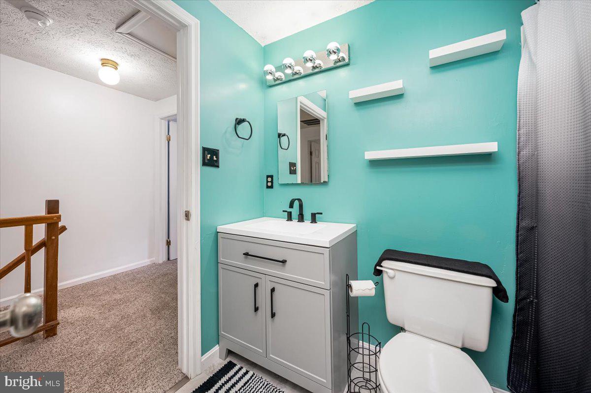 10109 Shelldrake Circle Damascus, MD 20872 - Photo 27 of 47 a bathroom with a toilet sink and mirror