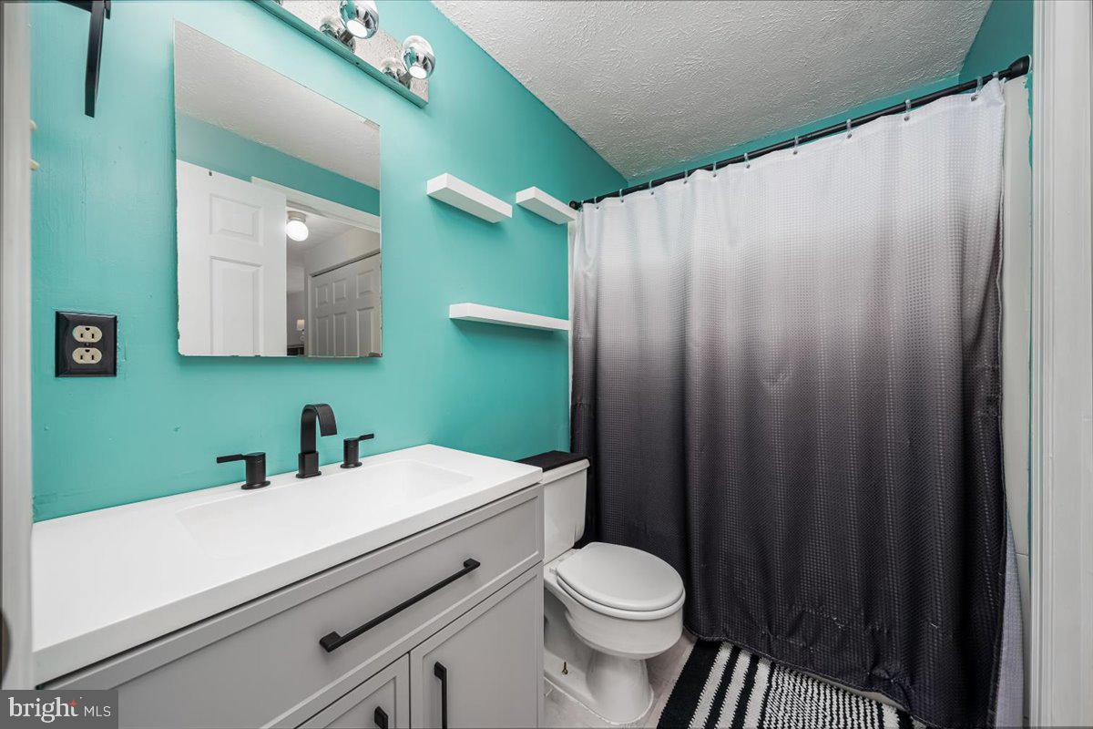 10109 Shelldrake Circle Damascus, MD 20872 - Photo 28 of 47 a bathroom with a sink a toilet and a mirror
