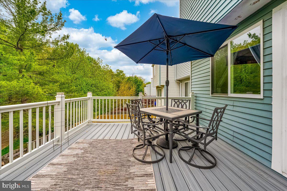 10109 Shelldrake Circle Damascus, MD 20872 - Photo 38 of 47 a view of balcony with furniture and umbrella