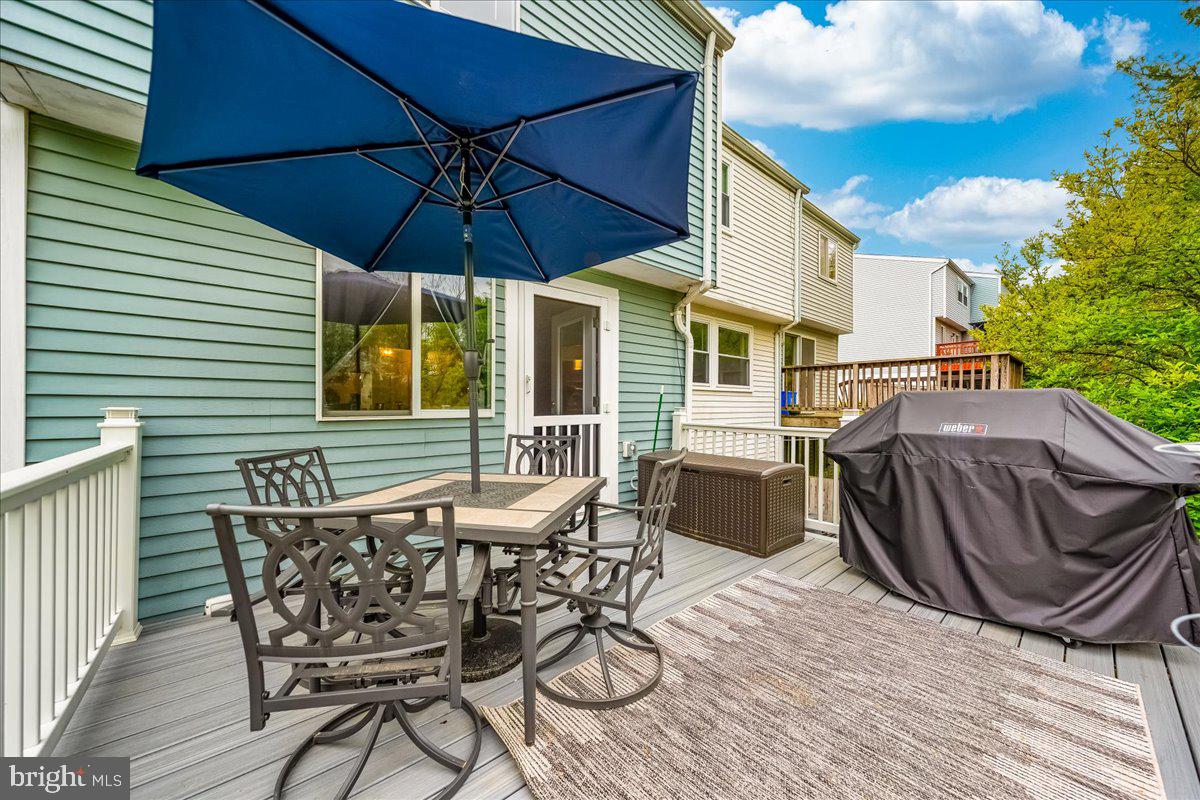 10109 Shelldrake Circle Damascus, MD 20872 - Photo 39 of 47 a view of patio with table and chairs under an umbrella