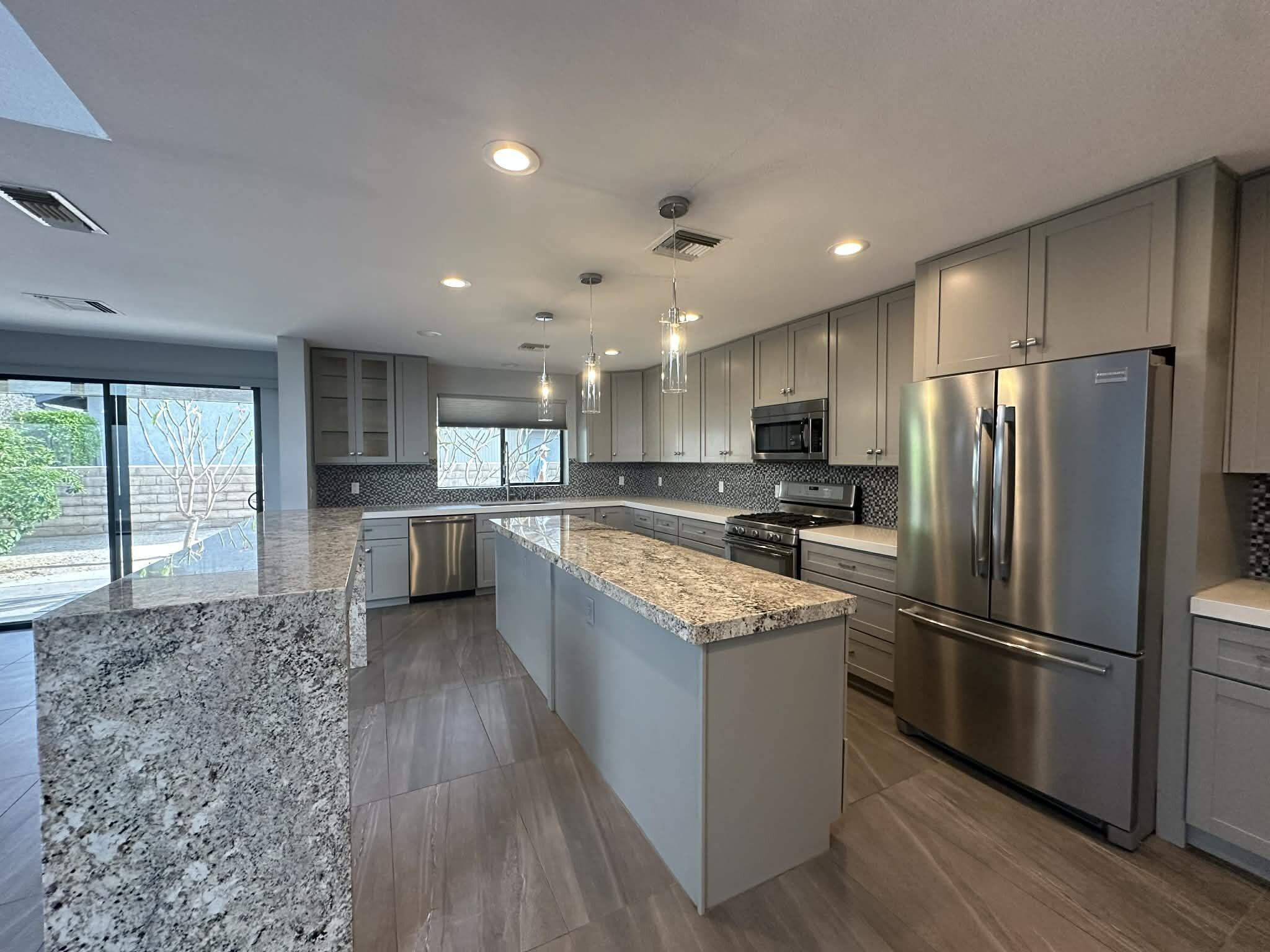 a kitchen with a refrigerator a sink and cabinets