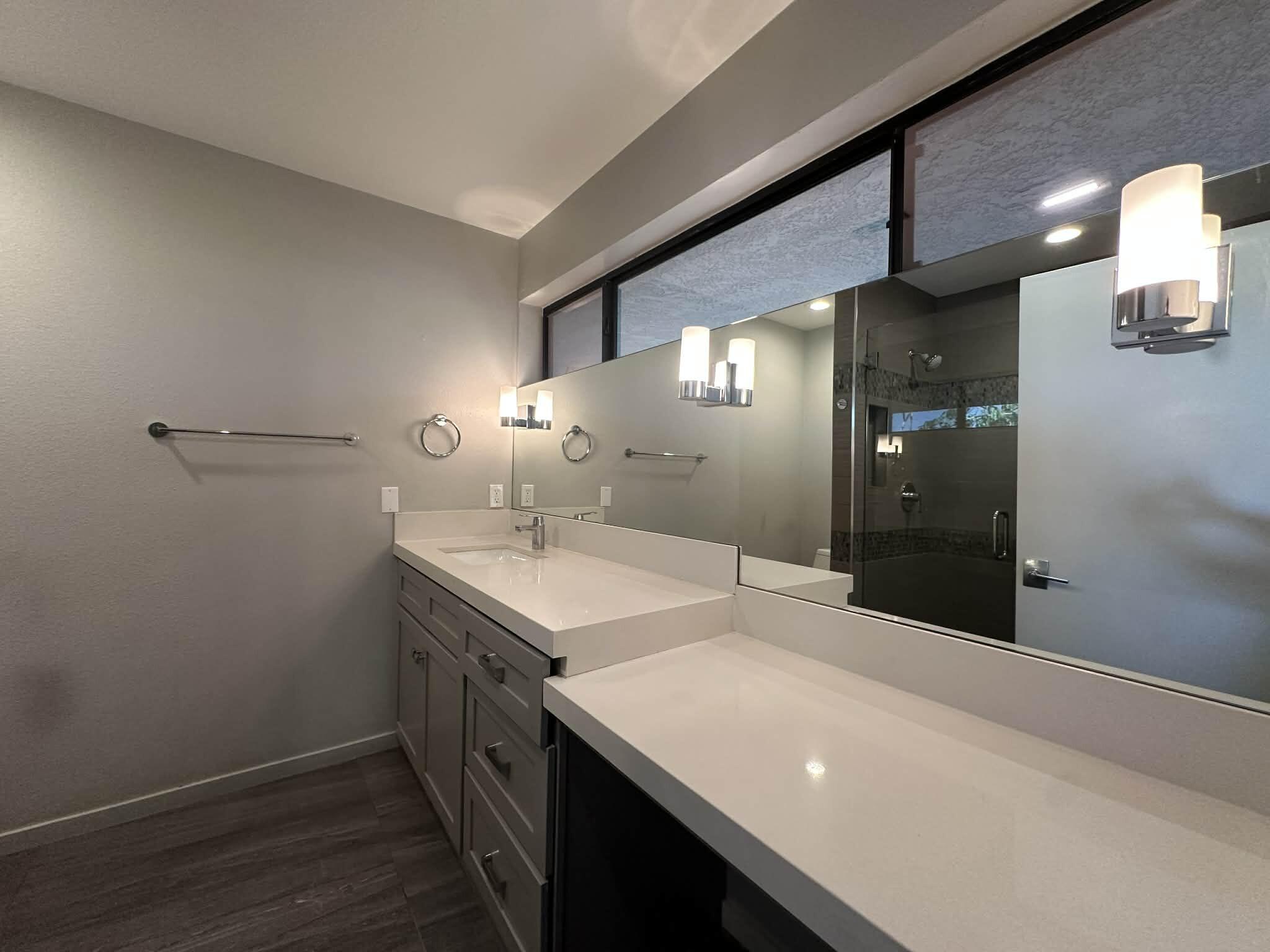4 Saturn Circle Rancho Mirage, CA 92270 - Photo 14 of 32 a bathroom with a sink and a mirror