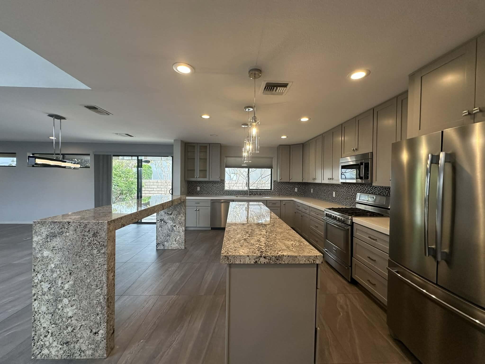 4 Saturn Circle Rancho Mirage, CA 92270 - Photo 19 of 32 a large kitchen with kitchen island a sink stainless steel appliances and a counter top space