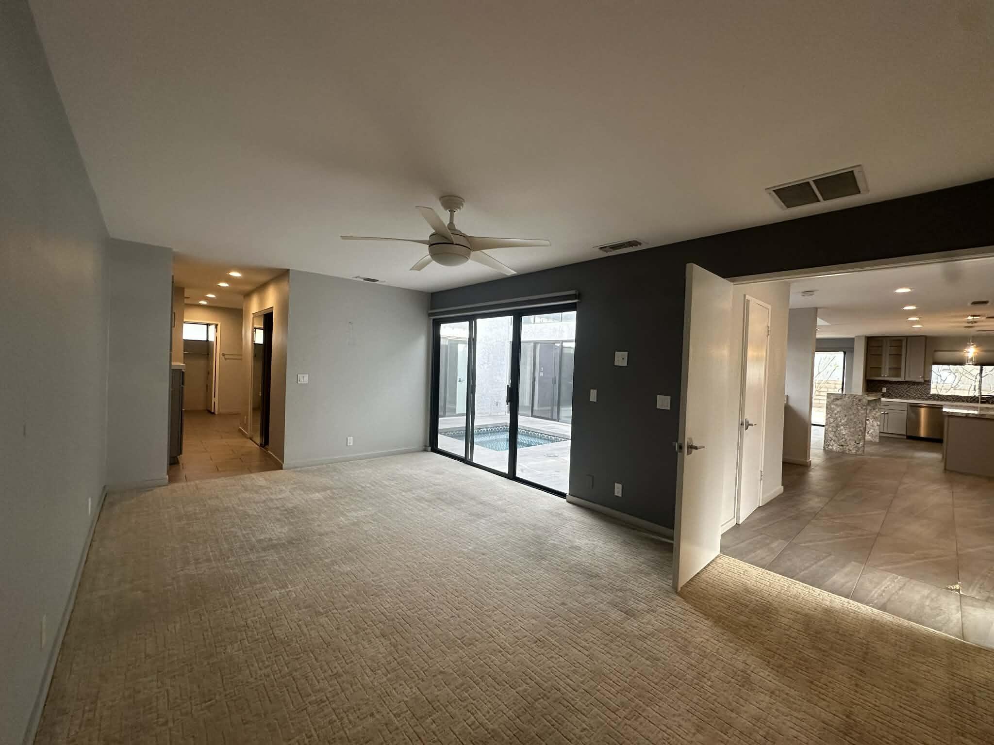 4 Saturn Circle Rancho Mirage, CA 92270 - Photo 22 of 32 a view of a big room with windows and chandelier