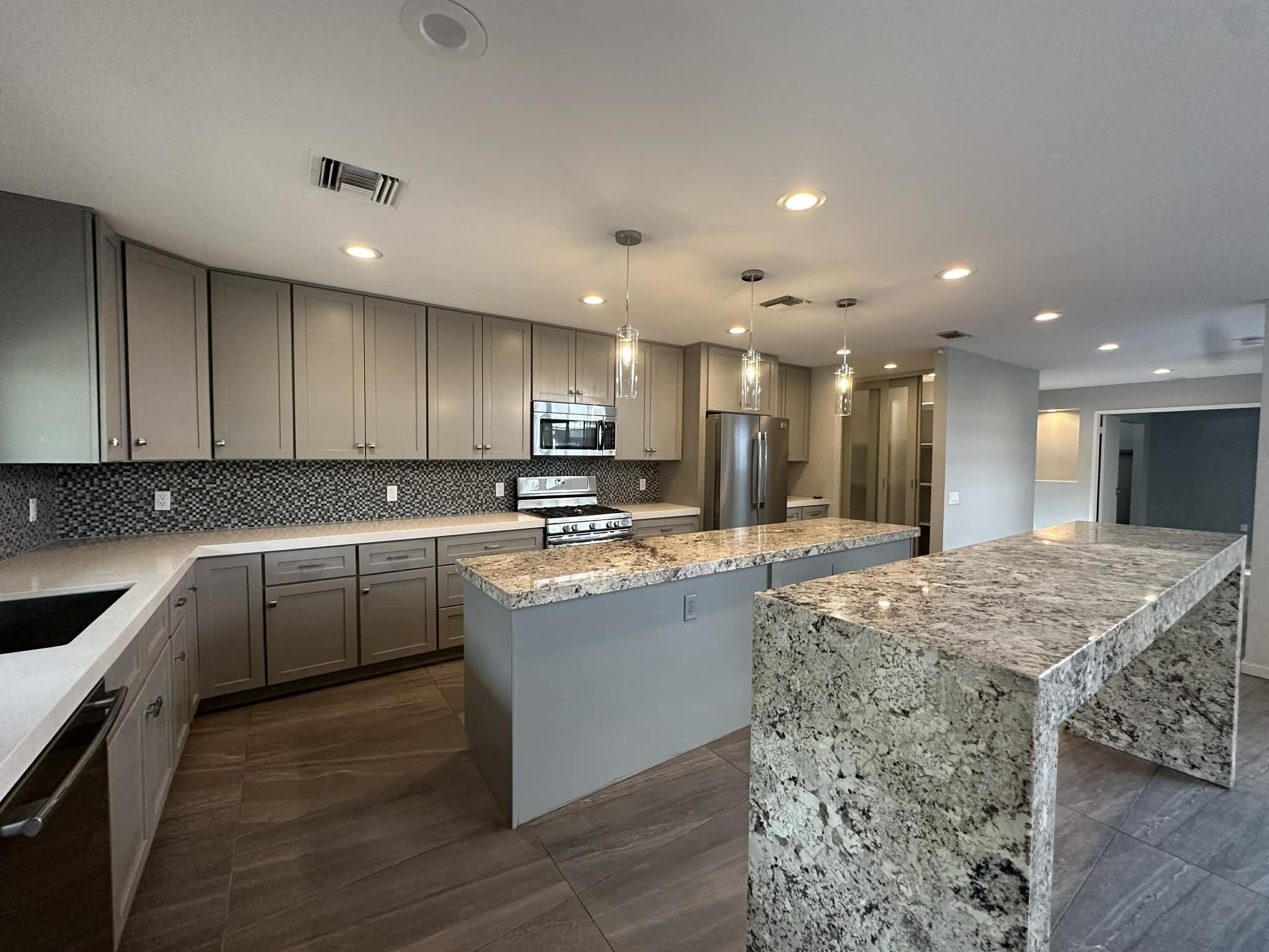 4 Saturn Circle Rancho Mirage, CA 92270 - Photo 4 of 32 a kitchen with stainless steel appliances kitchen island granite countertop a sink and cabinets