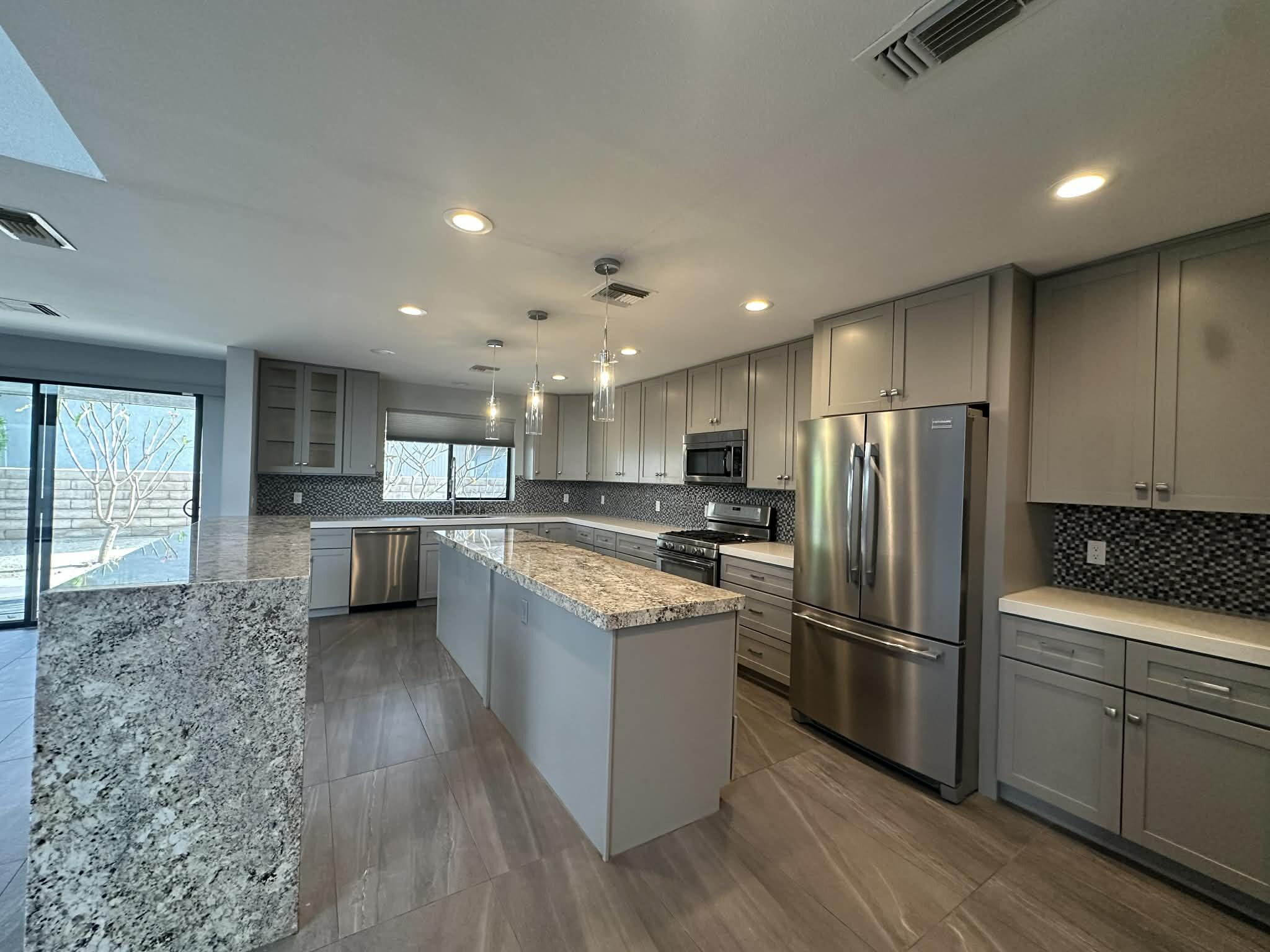 4 Saturn Circle Rancho Mirage, CA 92270 - Photo 6 of 32 a kitchen with a refrigerator a sink and cabinets