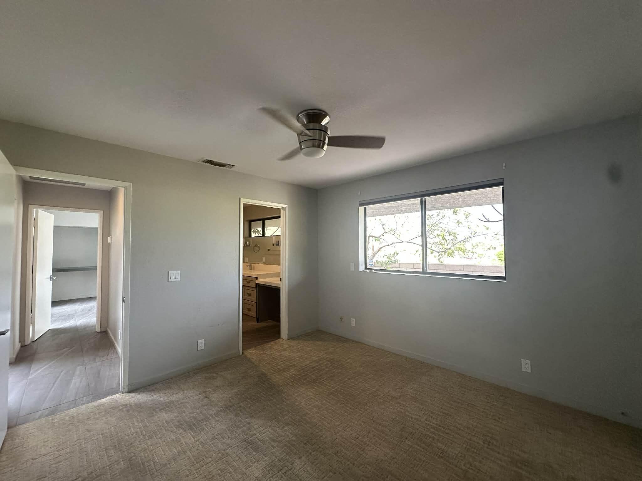 4 Saturn Circle Rancho Mirage, CA 92270 - Photo 10 of 32 an empty room with a ceiling fan and window